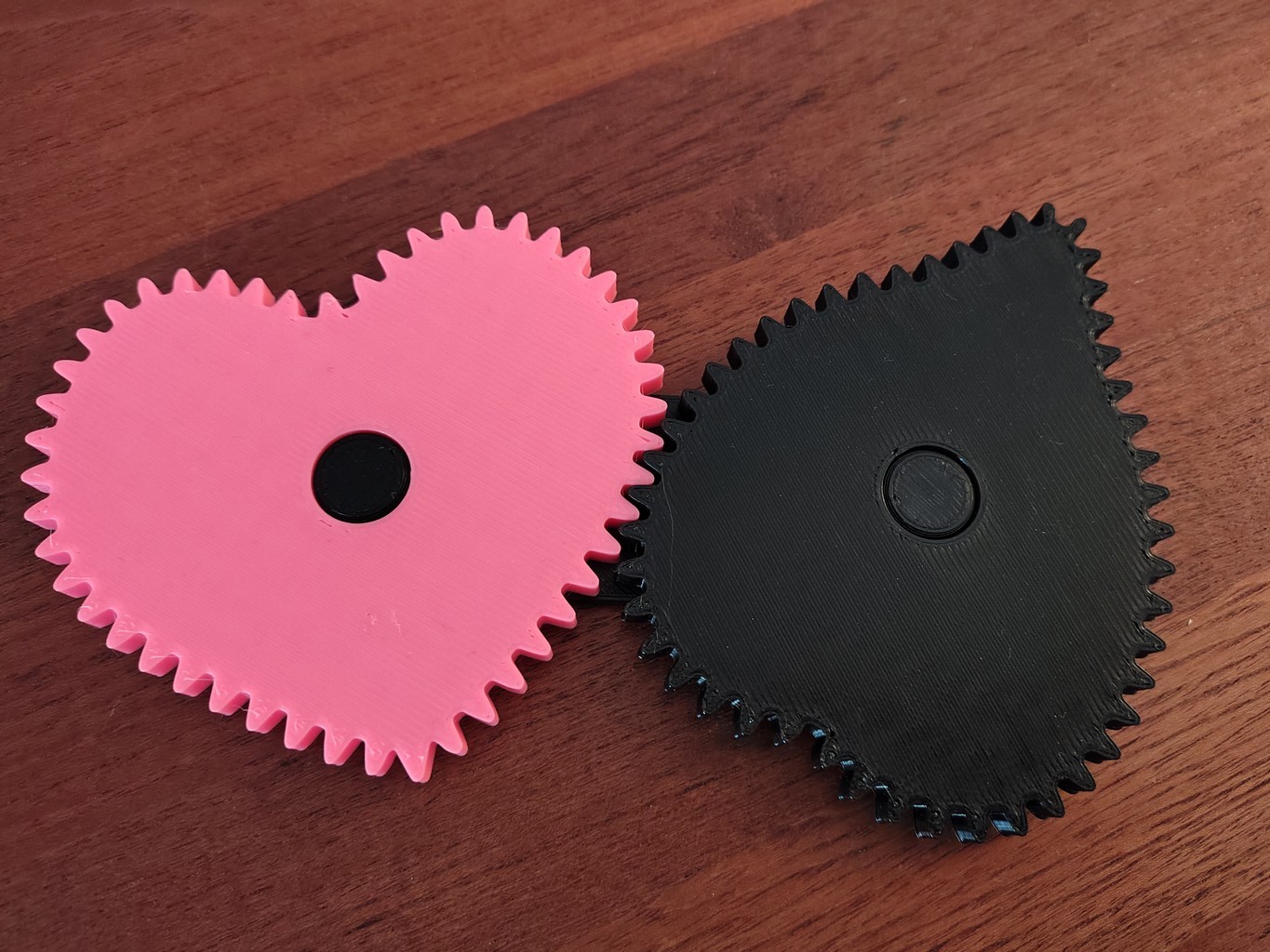 3D-printed pink and black gear pair