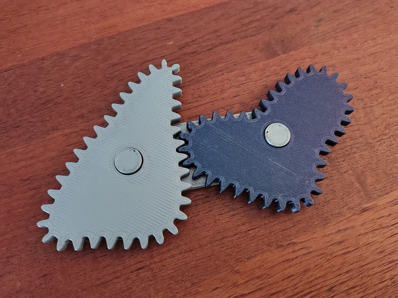 3D-printed light grey and dark grey gear pair