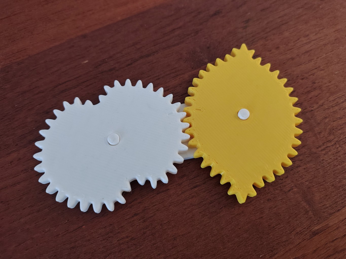 3D-printed white and yellow gear pair